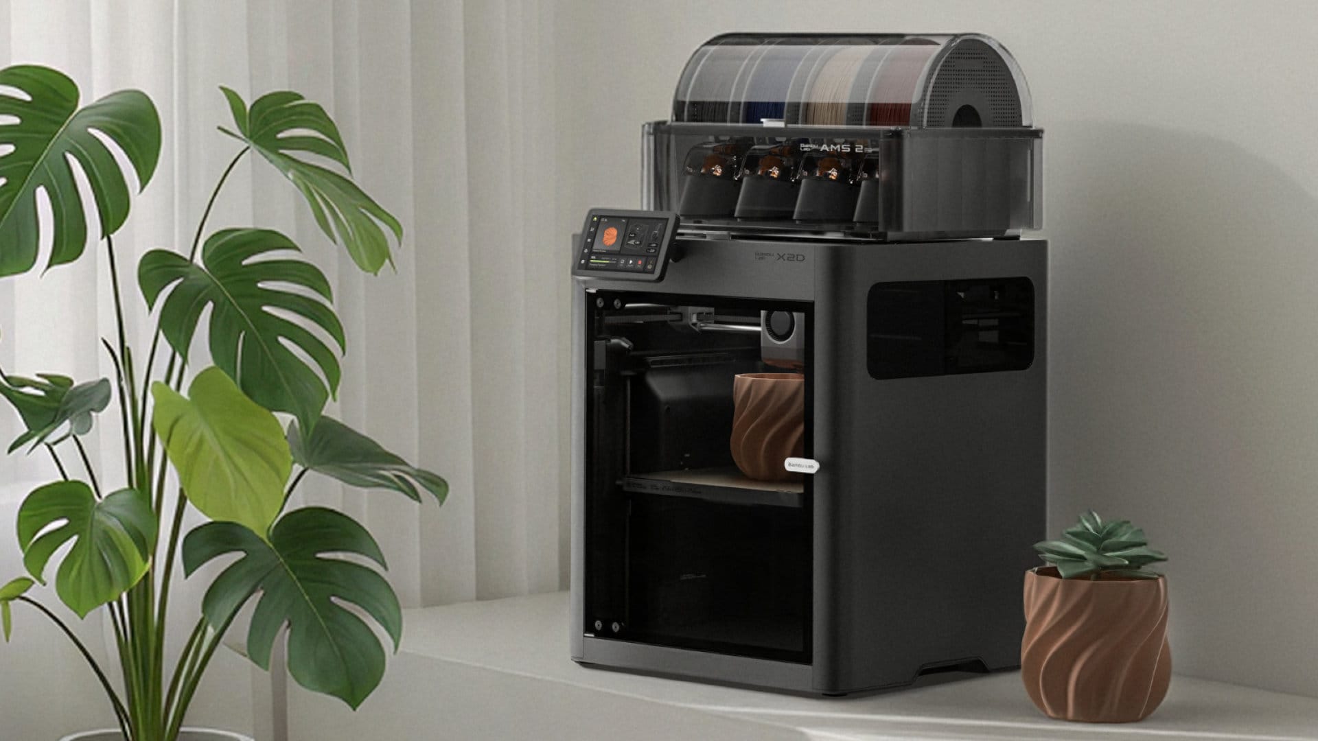Bambu Lab X2D 3D printer with AMS 2 Pro and a printed planter